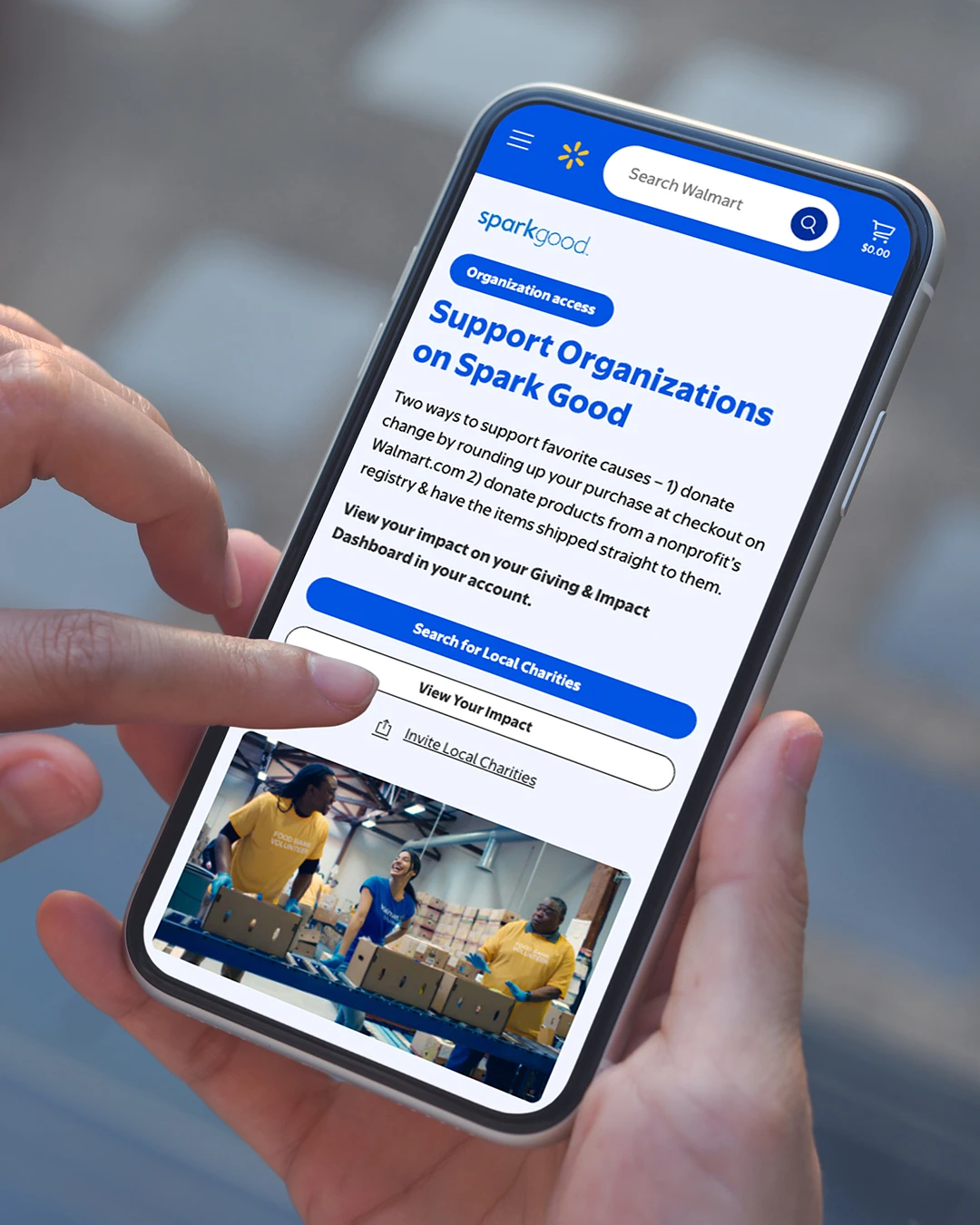 A person holds a smartphone and interacts with a donation or support application on the screen. The interface shows a section titled "Support Organizations on Spark Good" with blue buttons and text fields. The user’s finger is poised to tap a call-to-action button, suggesting online giving or charitable support. The background is softly blurred, keeping focus on the mobile device and the app interface.